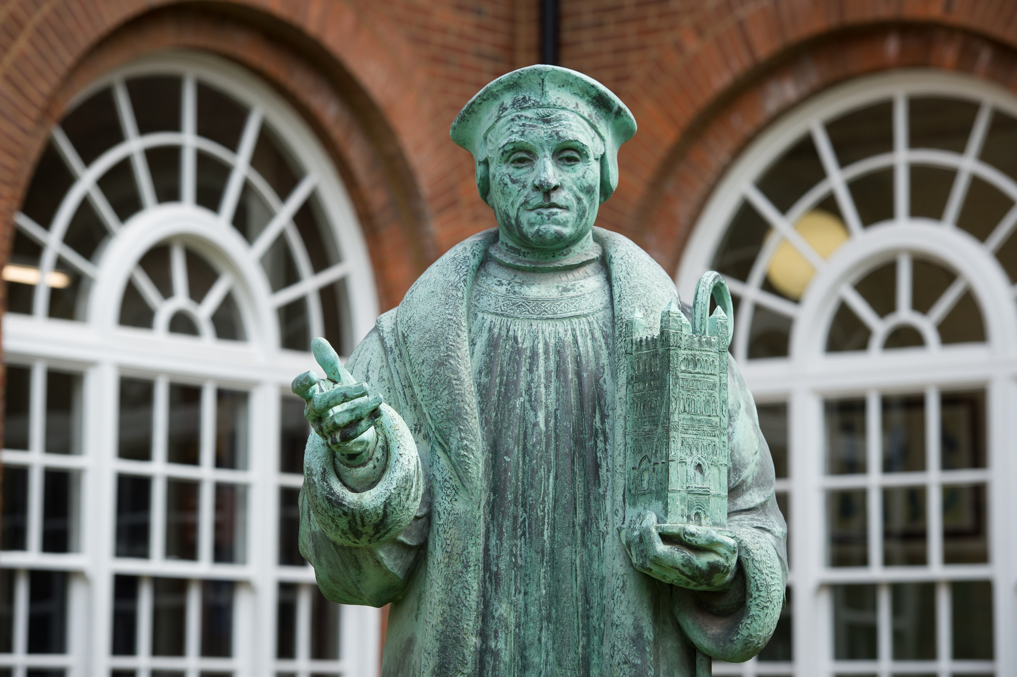 Life size bronze statue of hugh oldham by william macmillan in the school grounds unveiled in 1931